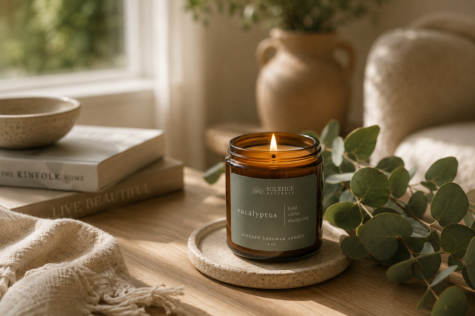 Solstice Naturals Eucalyptus beeswax candle burning in a naturally lit home setting